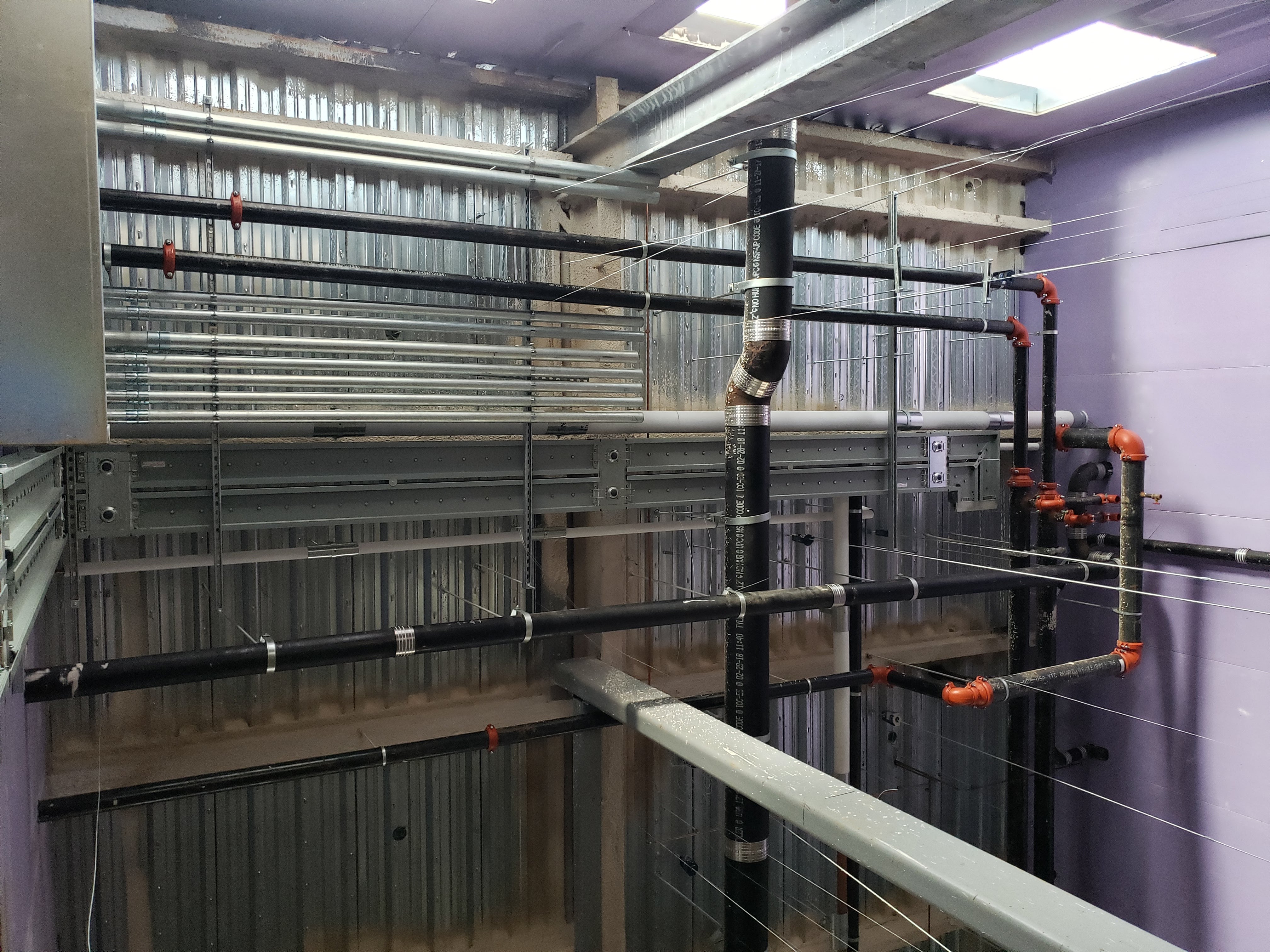 Overhead coordination shot conduit and sprinkler mains