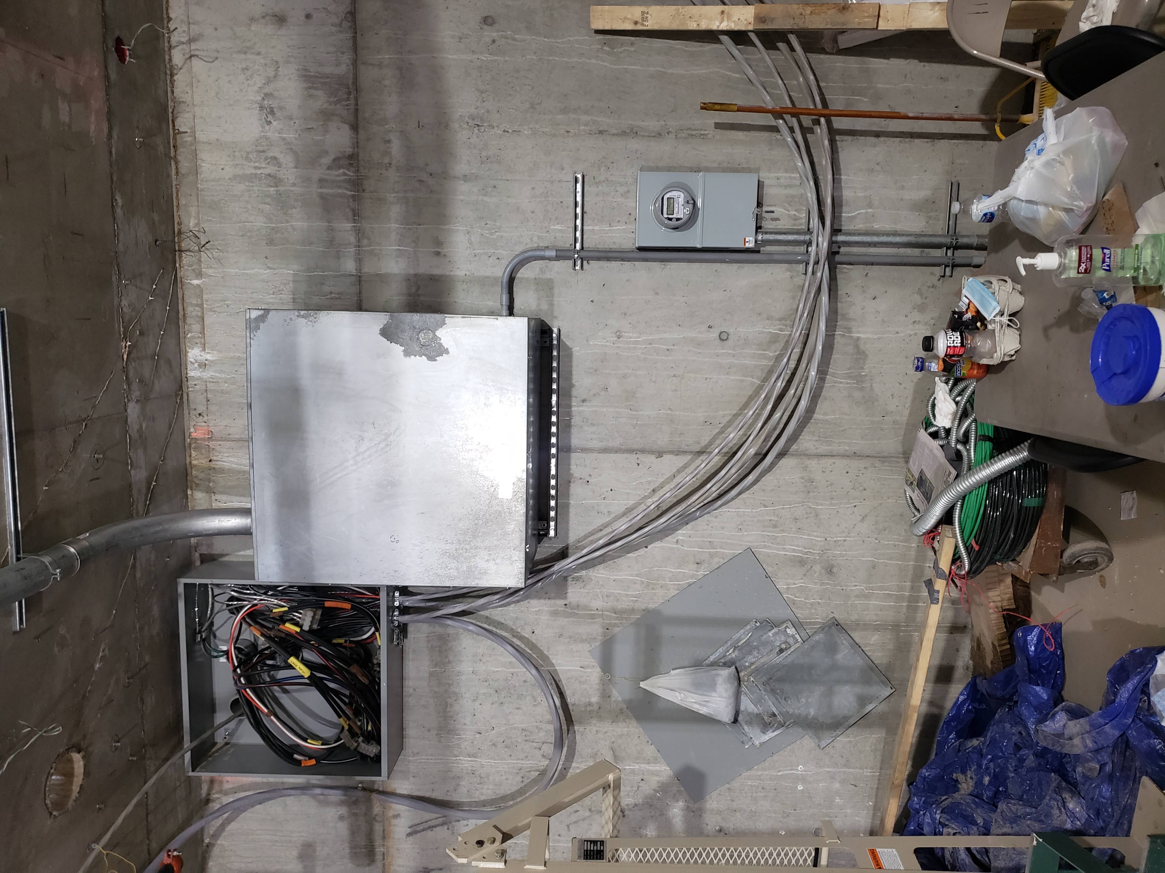 Basement temporary power panel and conduit risers
