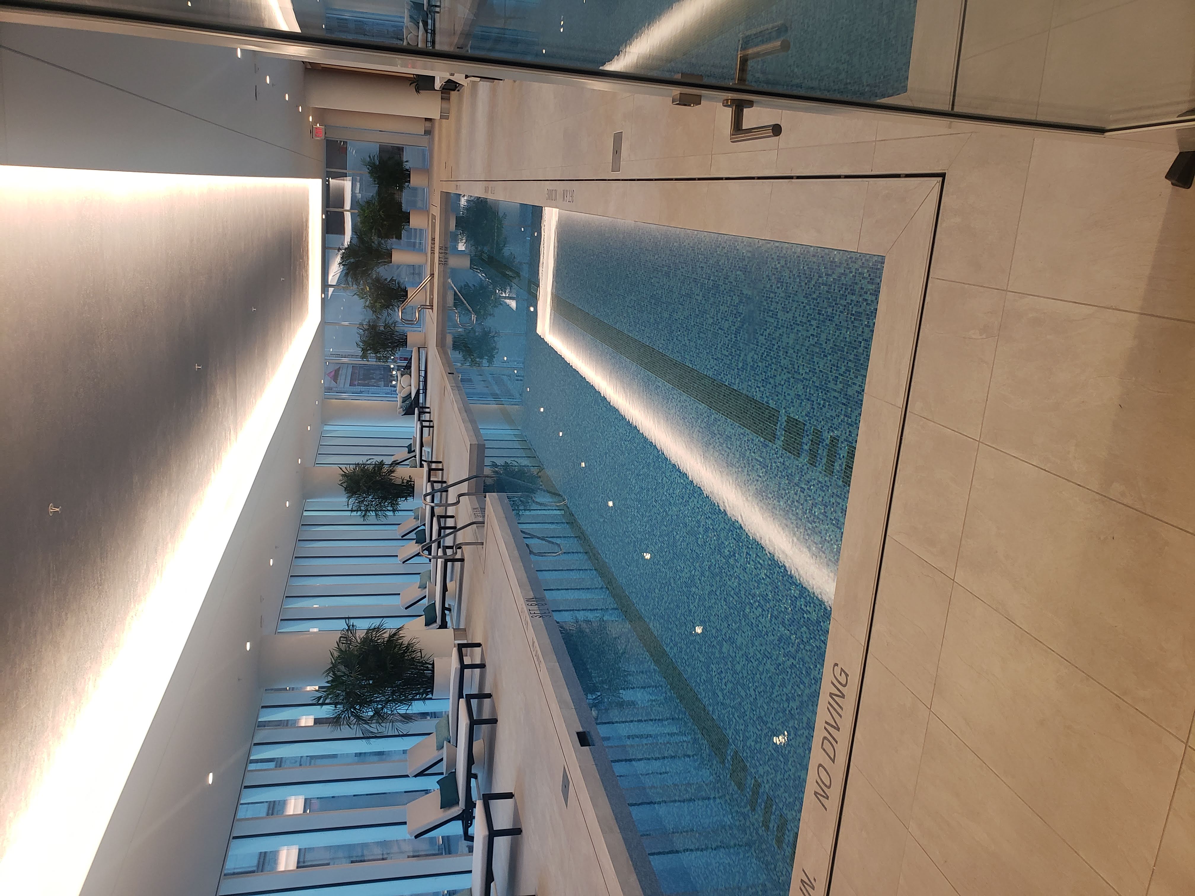 Indoor lap pool with cove and recessed lighting