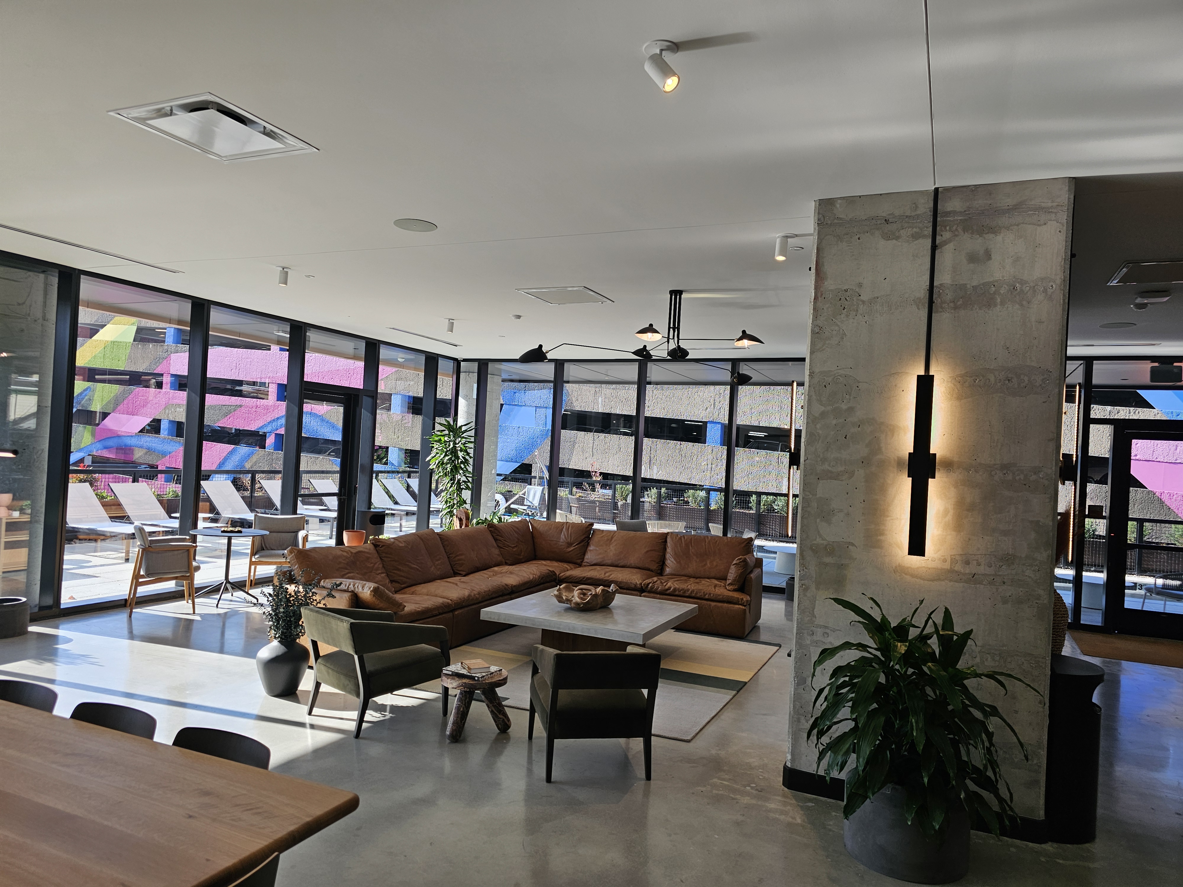 Amenity lounge with track lighting and polished concrete