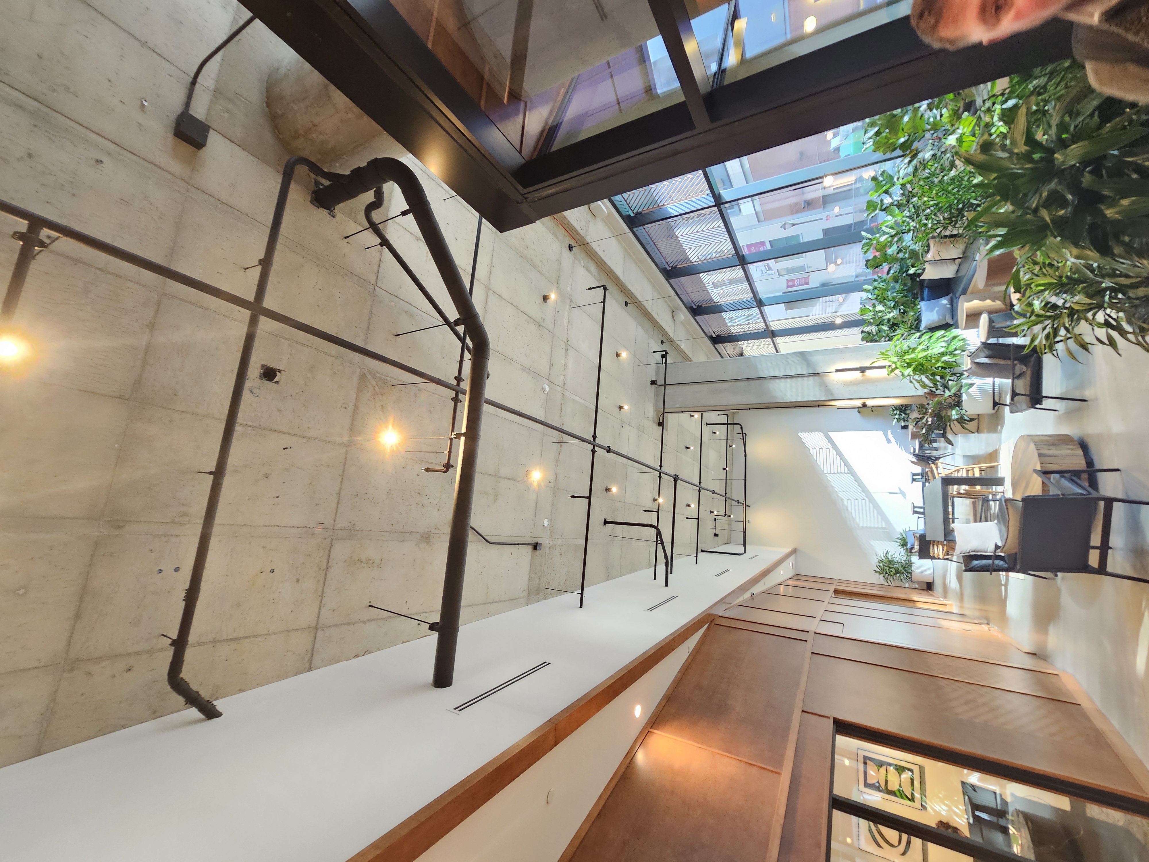 Lobby with decorative black EMT on exposed concrete ceiling